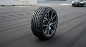 A high-angle, professional editorial shot of a modern car tire on clean asphalt with soft motion blu
